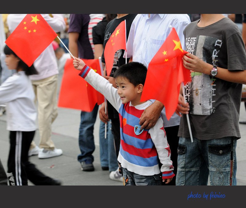 成都街头,男孩将比自己大一圈的国旗扶正,你从男孩身上看到了哪些品质?
